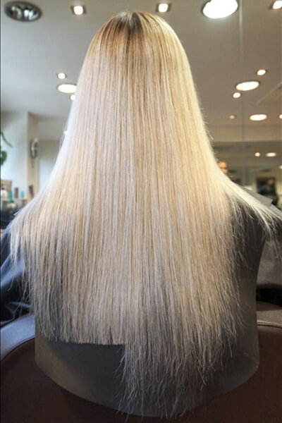 Larisa Love's client showing her hair being trimmed