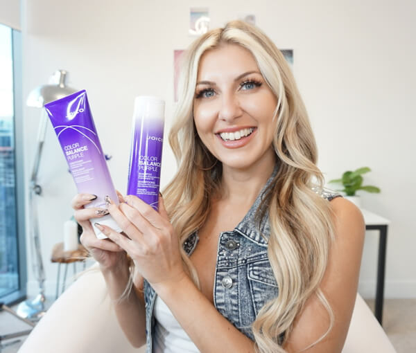 stylist with color balance purple shampoo and conditioner hair products