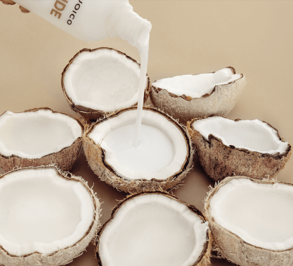 coconut developer pouring into coconuts